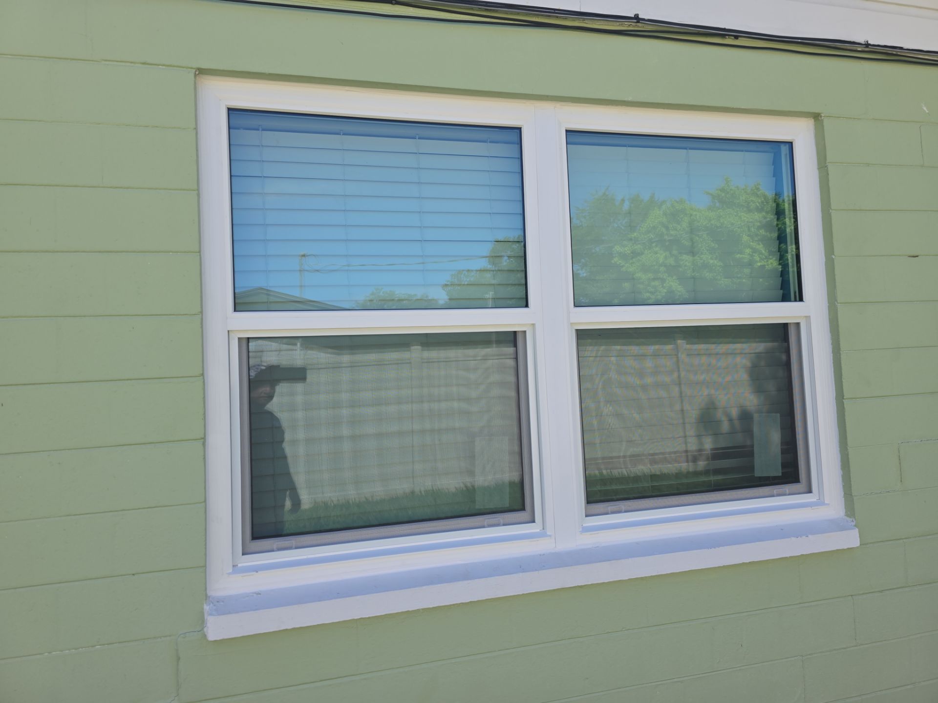 After: Front elevation with new impact windows and impact entry door system.