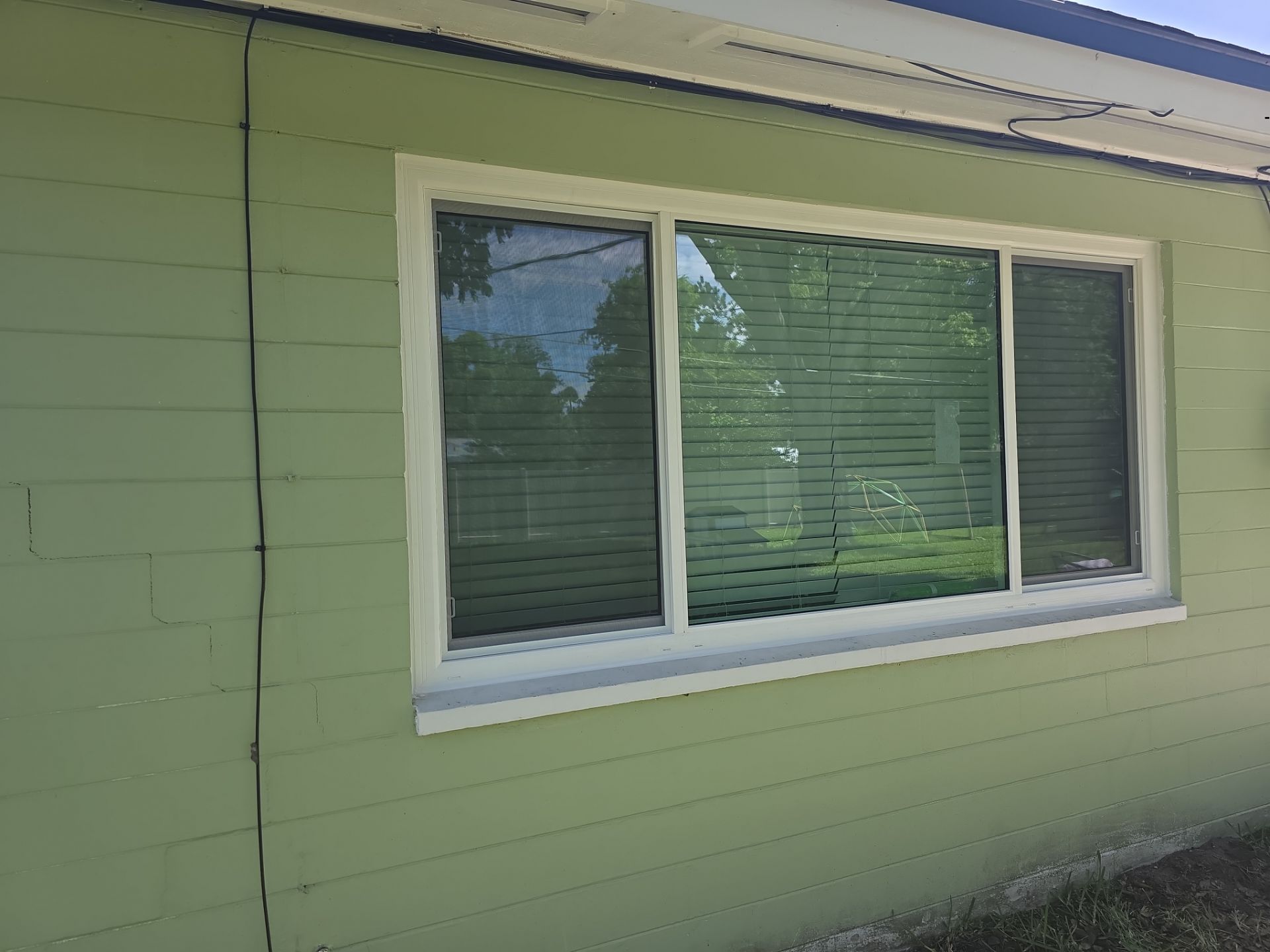 After: Side elevation showing matched white frame finish across all impact window openings.
