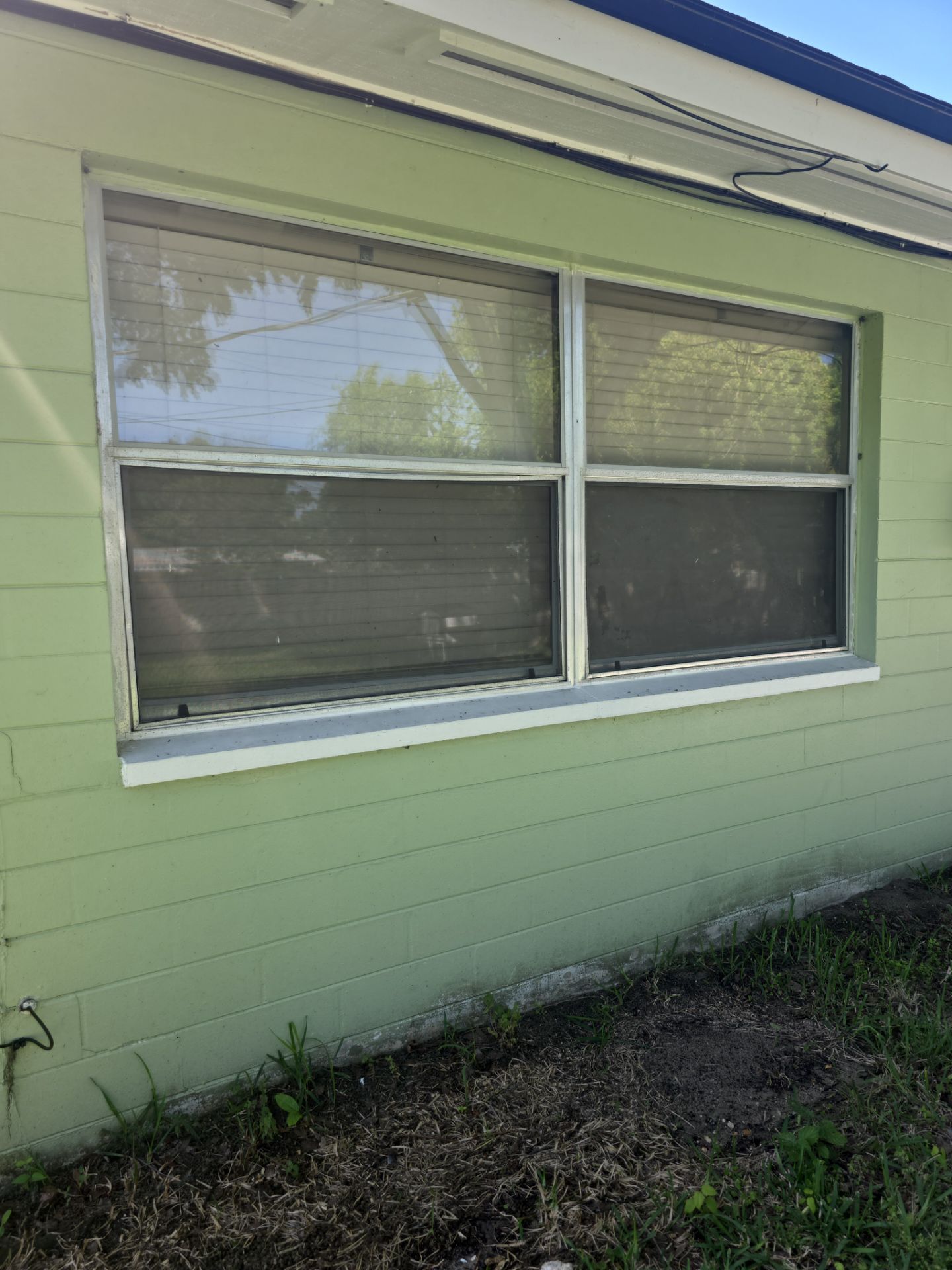 Before: Side elevation showing matched white frame finish across all impact window openings.